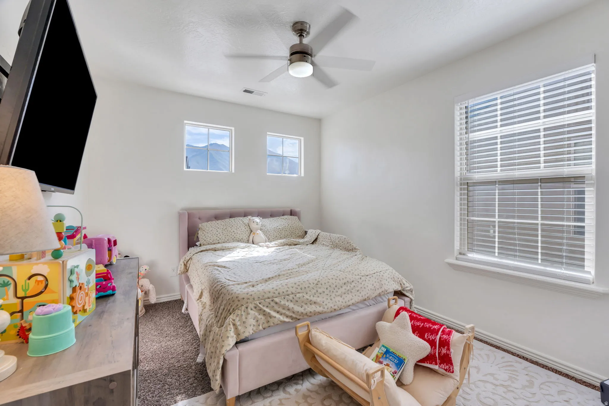 Recessed lighting, ceiling fan, carpeted flooring, and multiple windows with blinds