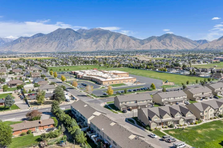 Expansive mountain backdrop with a residential community and green spaces