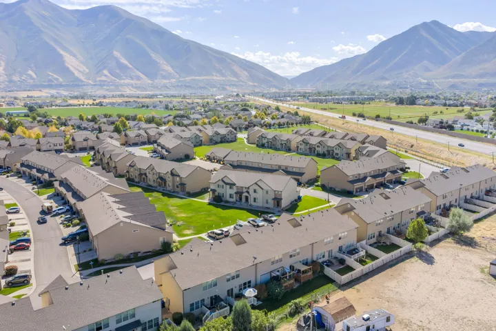 Residential community featuring townhomes with asphalt shingle roofs and private fenced yards