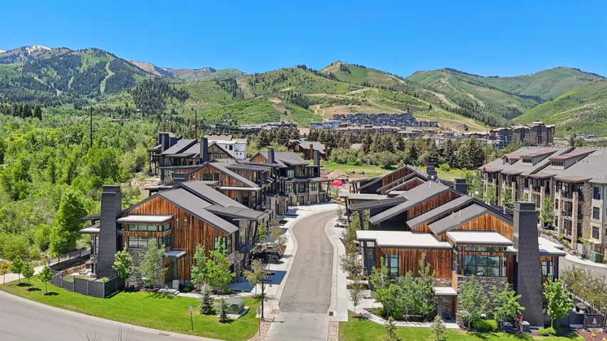 Contemporary residential structures featuring wood-paneled and stone exteriors
