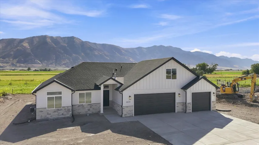 Contemporary-style exterior with white siding and stone accents