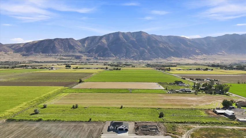 Expansive rural landscape featuring agricultural fields and distant mountains