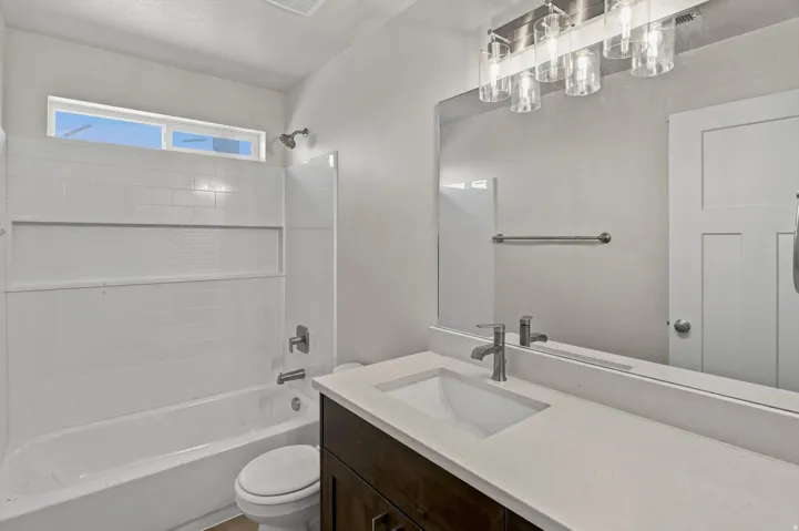 Vanity with an integrated rectangular sink and light-colored countertop