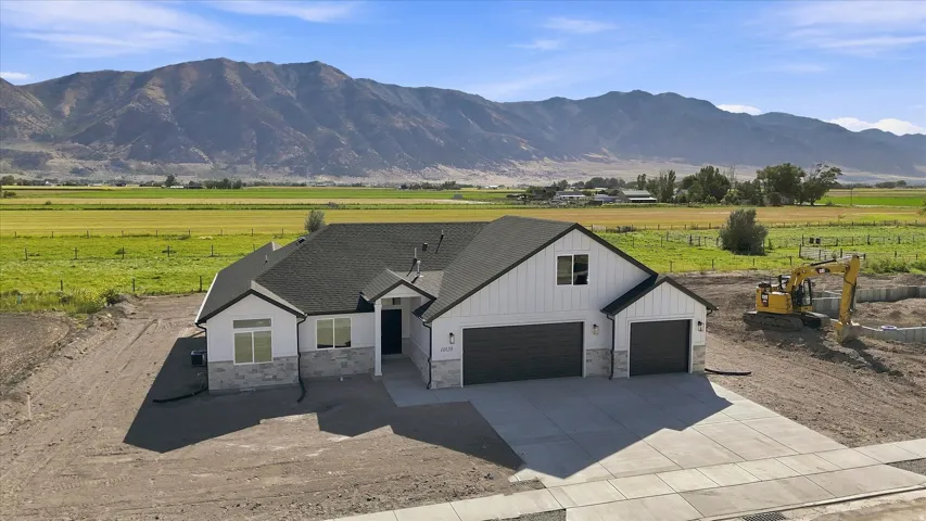 Contemporary exterior with a dark asphalt shingle roof, white vertical and horizontal siding, and light grey stone veneer accents