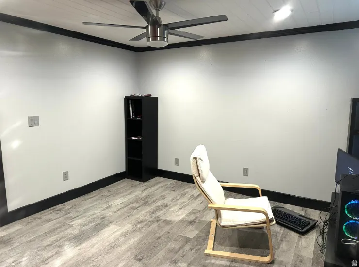Wood-finish flooring, ceiling fan, recessed lighting, and white walls with dark trim