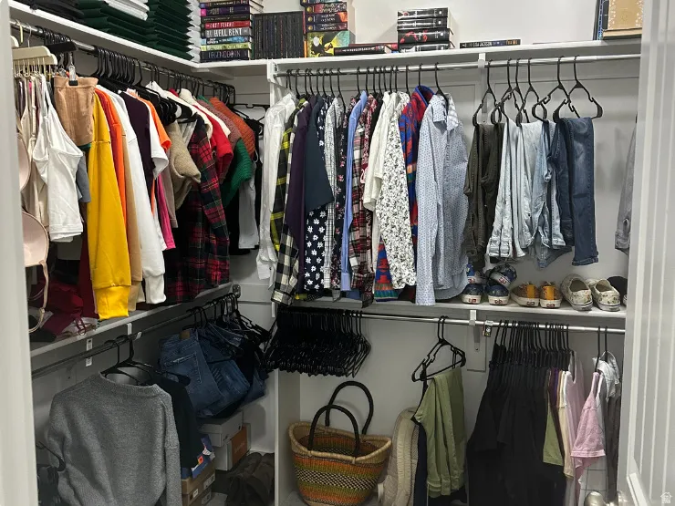 Built-in closet system with multiple hanging rods and shelving