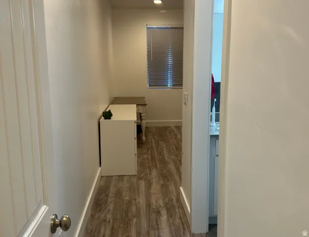 Wood-finish flooring throughout the hallway