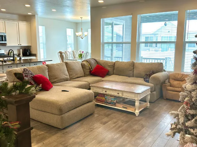 Christmas time. Open-concept living space featuring wood-finish flooring, recessed lighting, and large windows