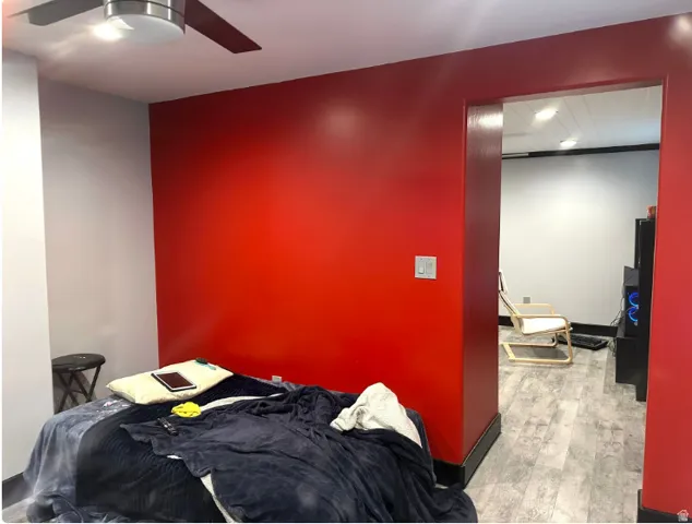 Recessed lighting, ceiling fan, wood-finish flooring, and a cased opening