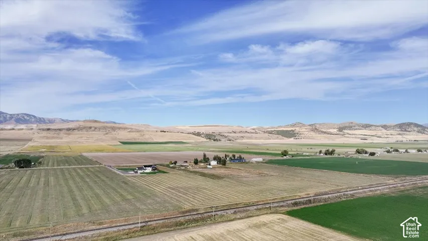 Expansive acreage featuring cultivated fields, undeveloped land, and distant structures