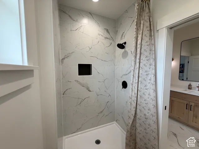 Tiled shower with matte black fixtures and a built-in shower niche