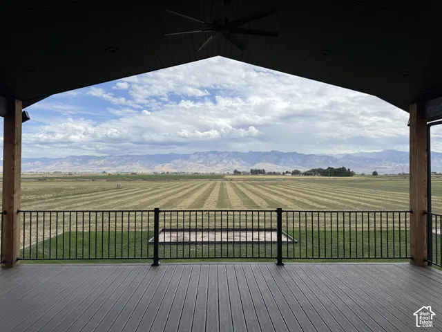 Expansive covered outdoor deck with composite decking and a black metal railing