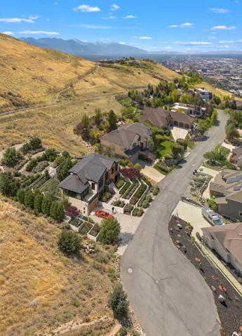 Modern residence with multi-level terraced landscaping, an attached garage, and a concrete driveway