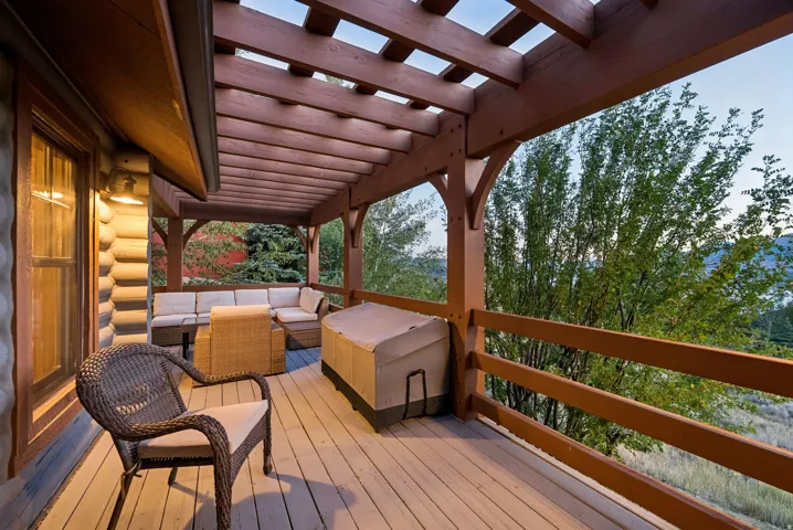 Expansive outdoor deck featuring a wood pergola and durable wood-finish flooring