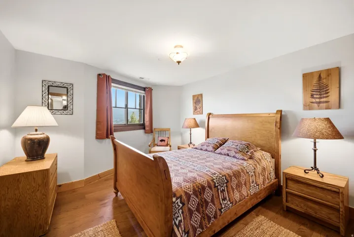 Hardwood flooring, light gray wall paint, window with grid panes, and a flush mount ceiling light