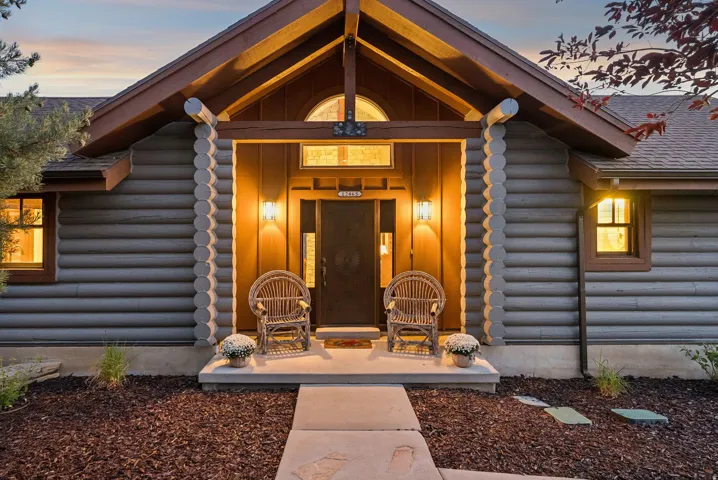 Log-style exterior with wood trim accents and a gabled entry