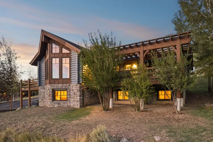 Stone and log siding exterior with a prominent A-frame architectural element