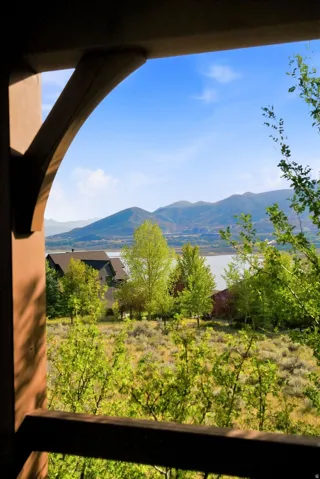 Architectural arched balcony framing a mountainous landscape with a body of water