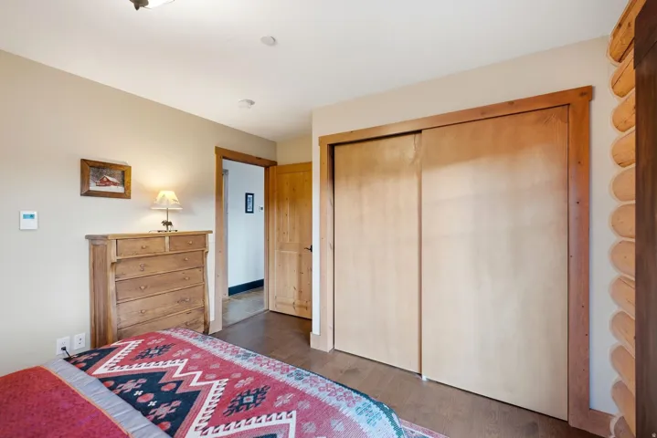 Wood-finish flooring, recessed lighting, and a built-in closet with sliding wood doors