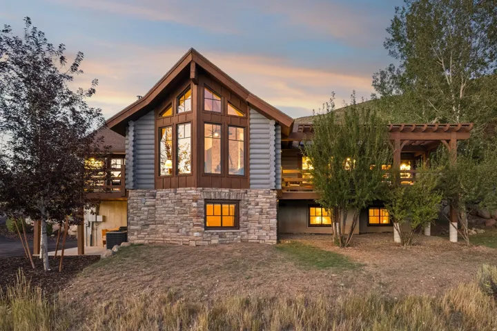 Stone and log exterior with a prominent A-frame window design