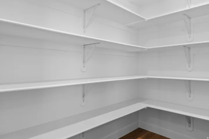 Wraparound shelving with white brackets, providing extensive storage space