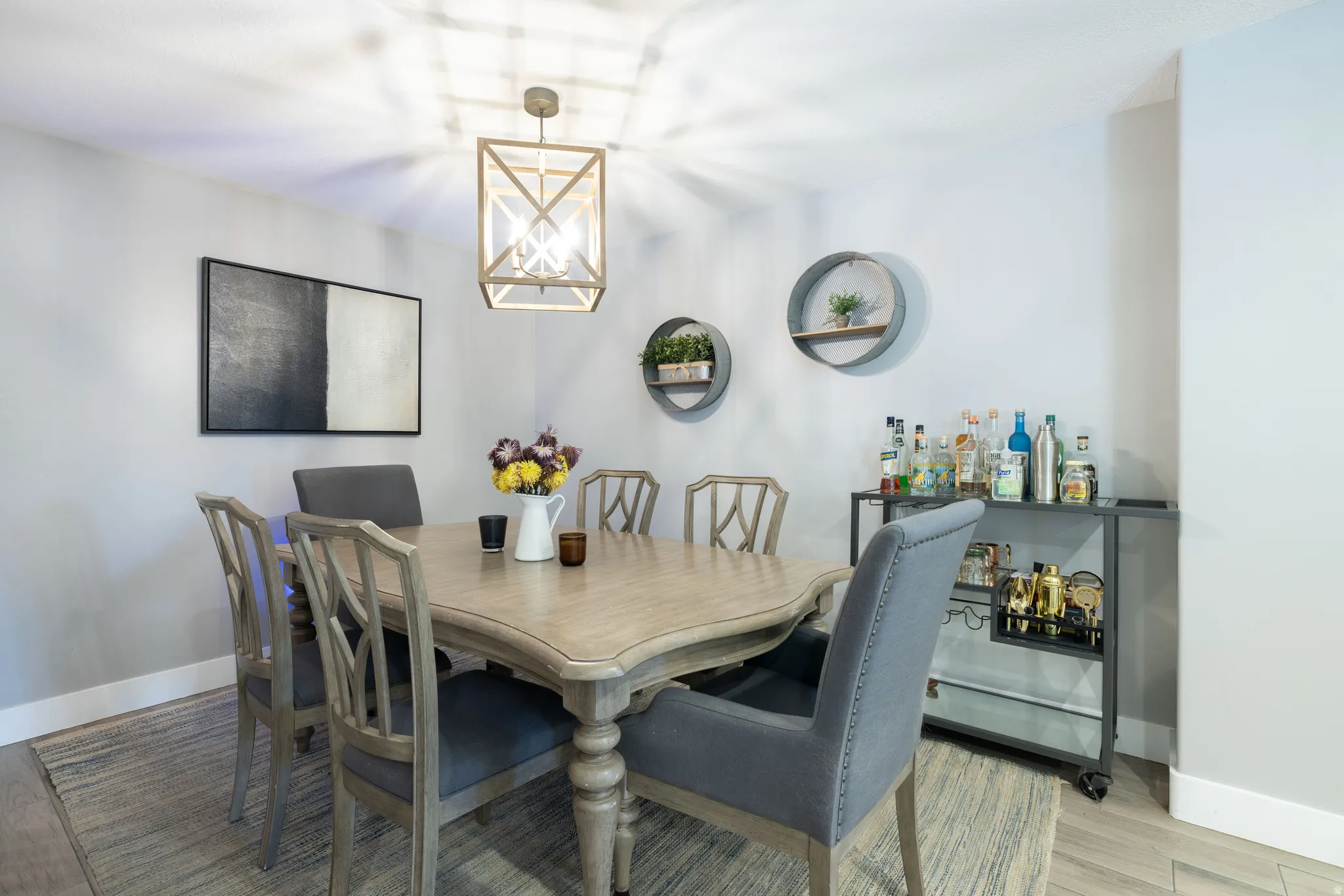 Wood-finish flooring with light-toned walls, featuring a decorative pendant light fixture