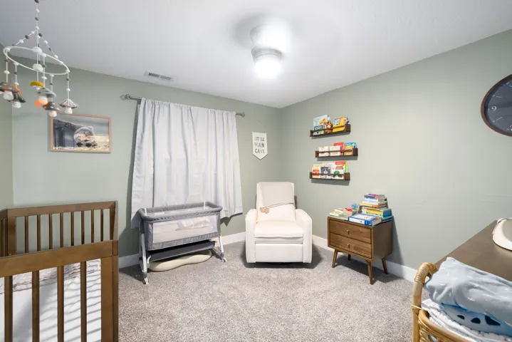 Recessed lighting fixture, light gray wall paint, white ceiling, gray carpet, white trim
