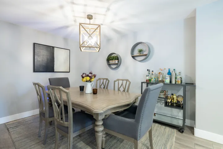 Wood-finish flooring with light-toned walls, featuring a decorative pendant light fixture