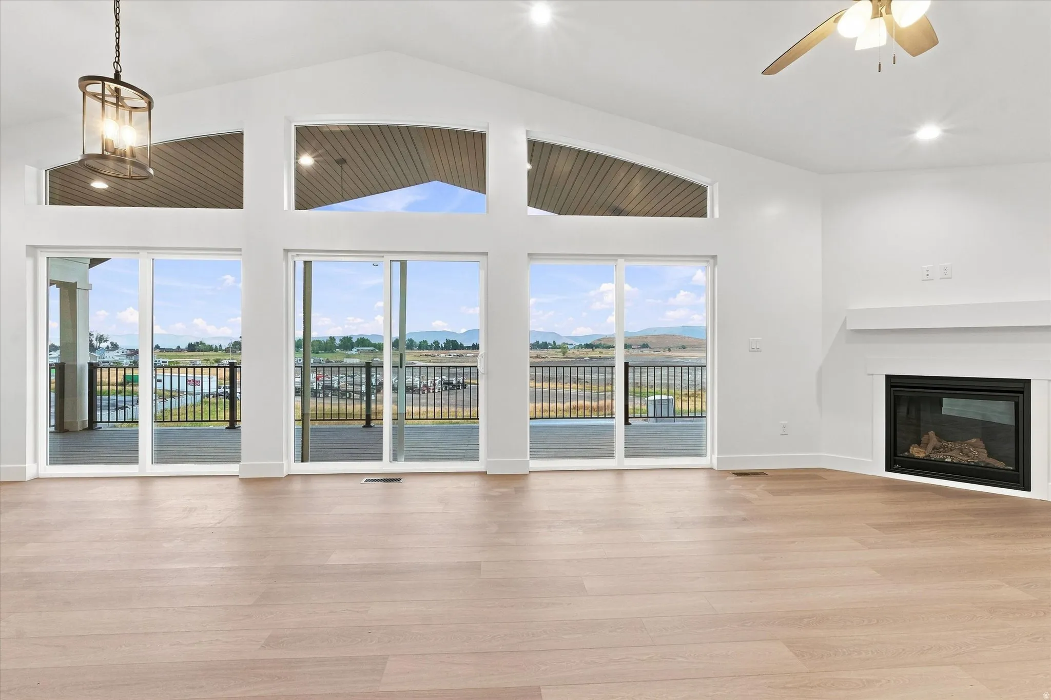 Vaulted ceiling with a contemporary chandelier and recessed lighting