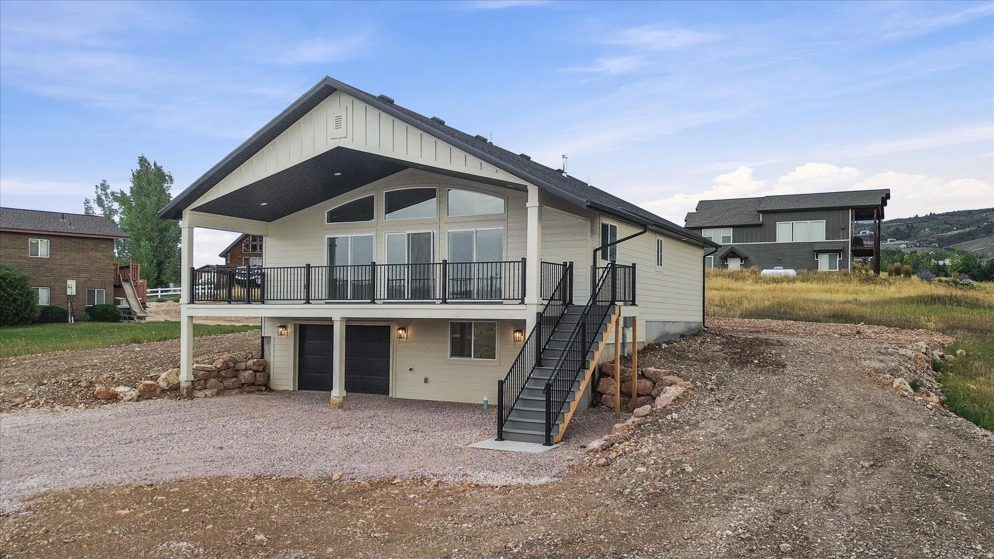 Modern-style residence featuring a prominent balcony, large windows, and a covered patio