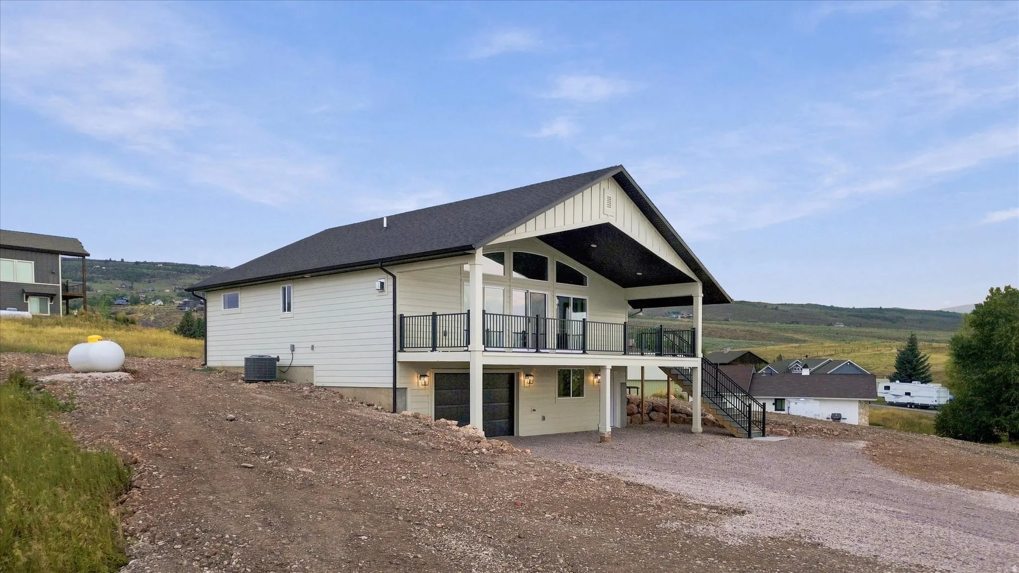 Contemporary exterior with white siding, black-framed windows, and a black shingled roof