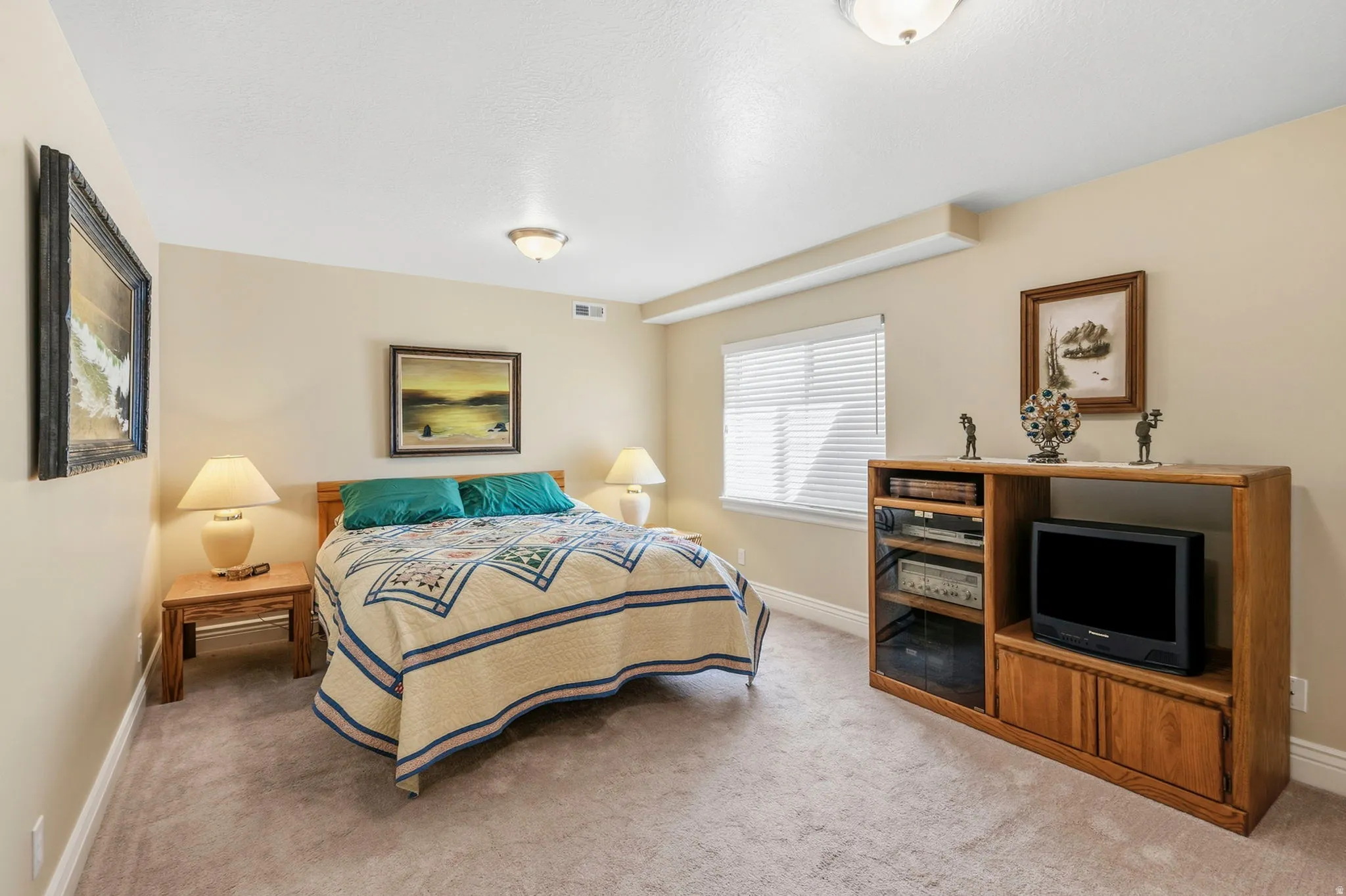 Carpeted flooring, window with blinds, and built-in ceiling lighting