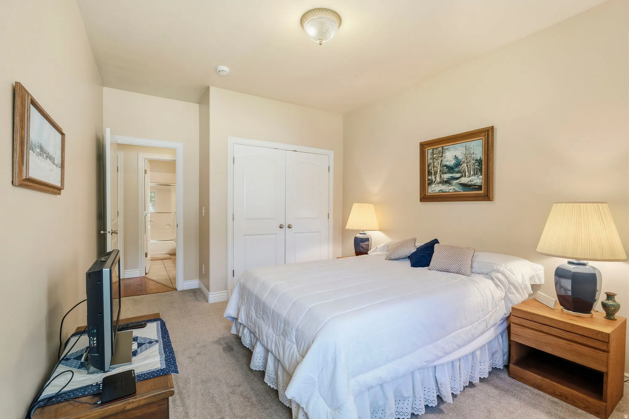 Neutral-toned walls complement the carpeted flooring
