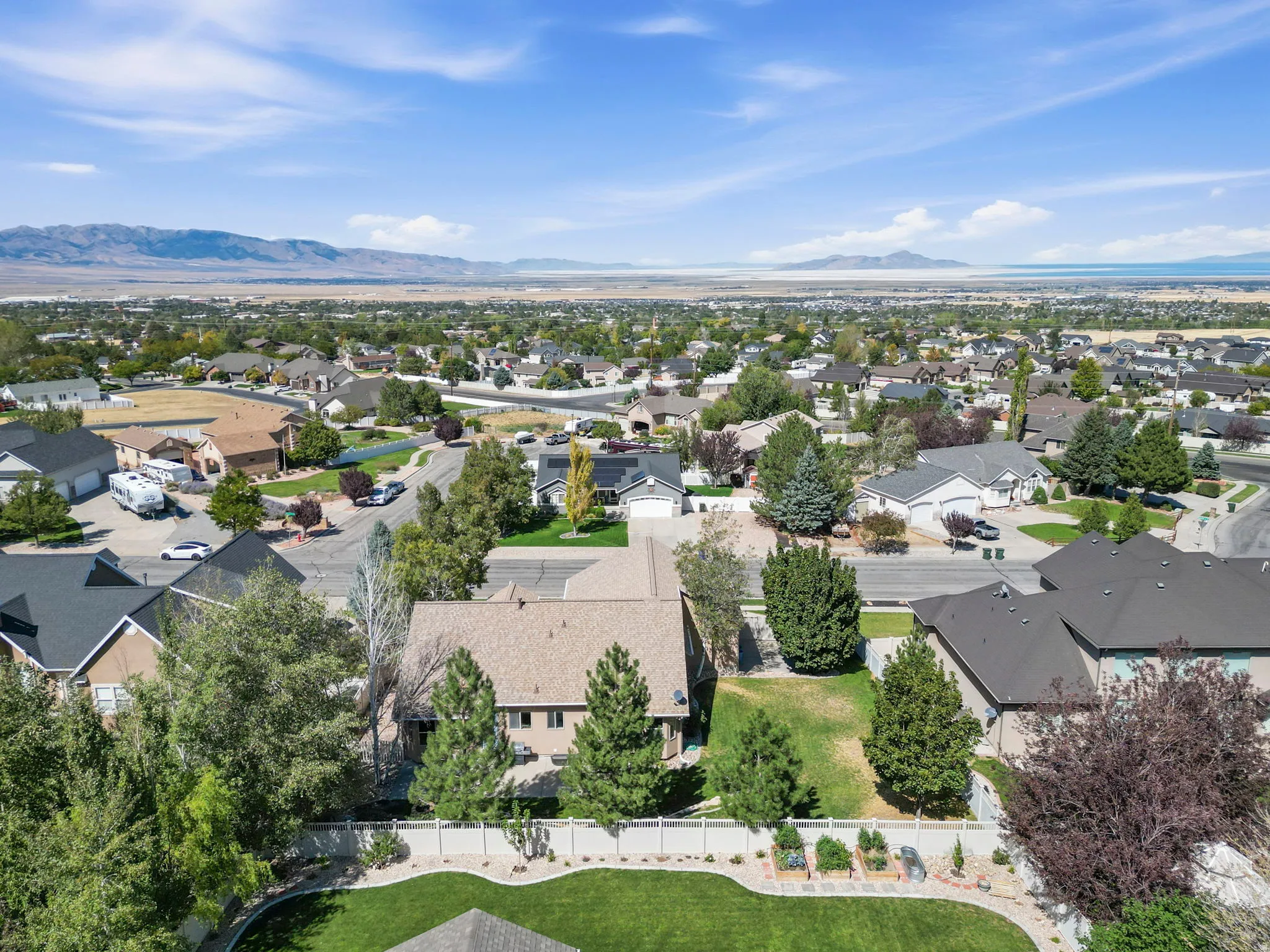 Expansive residential area with a prominent mountain backdrop and distant body of water