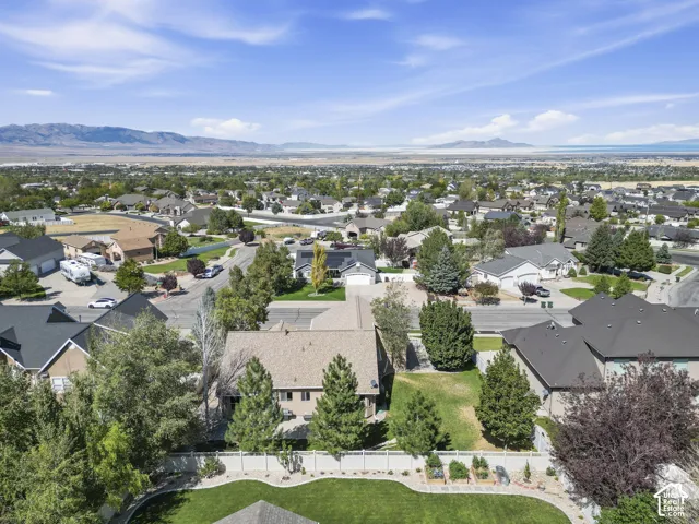 Expansive residential area with a prominent mountain backdrop and distant body of water