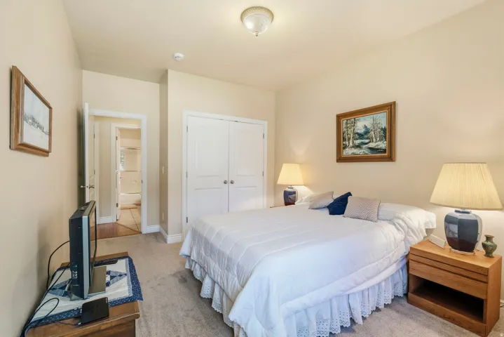 Neutral-toned walls complement the carpeted flooring