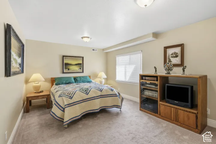 Carpeted flooring, window with blinds, and built-in ceiling lighting