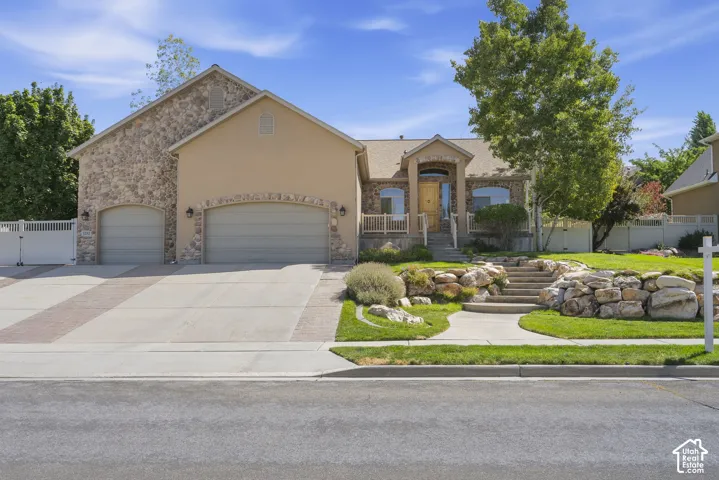 Stone and stucco exterior with an arched entryway