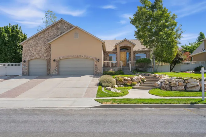 Stone and stucco exterior with an arched entryway