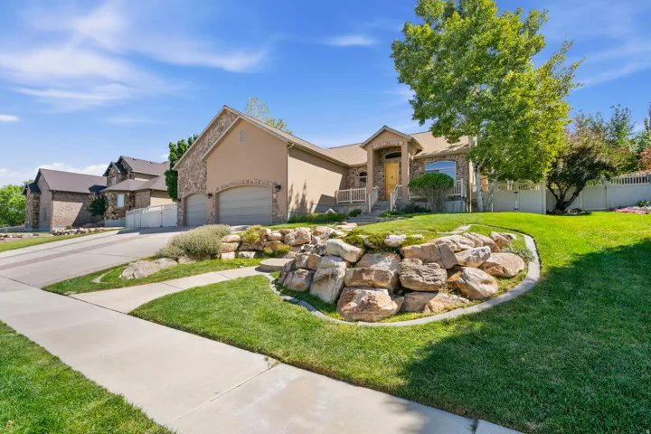 Stucco and stone exterior with an attached two-car garage
