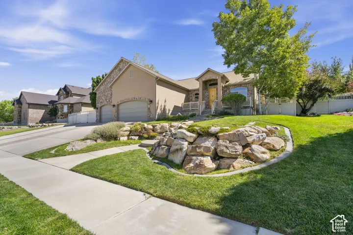 Stucco and stone exterior with an attached two-car garage
