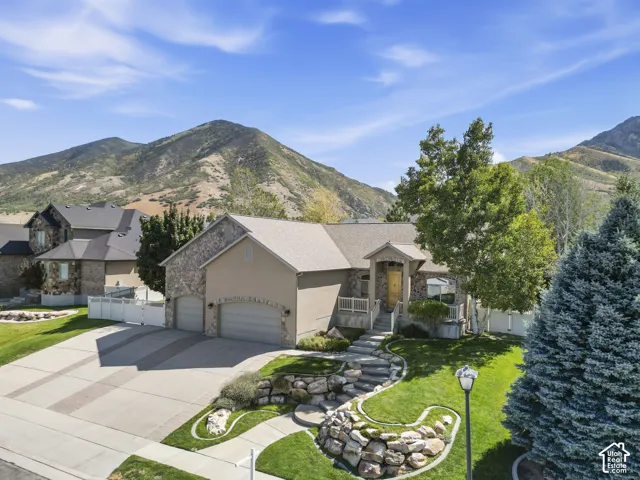 Stone and stucco exterior with an attached two-car garage