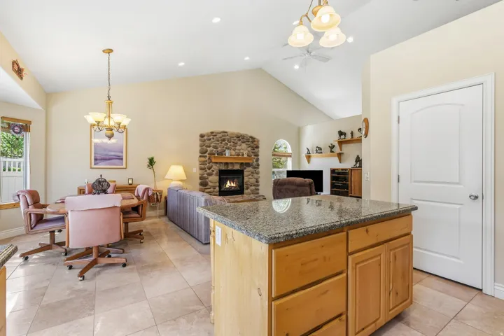 Kitchen island with granite countertop and natural wood-finish cabinetry