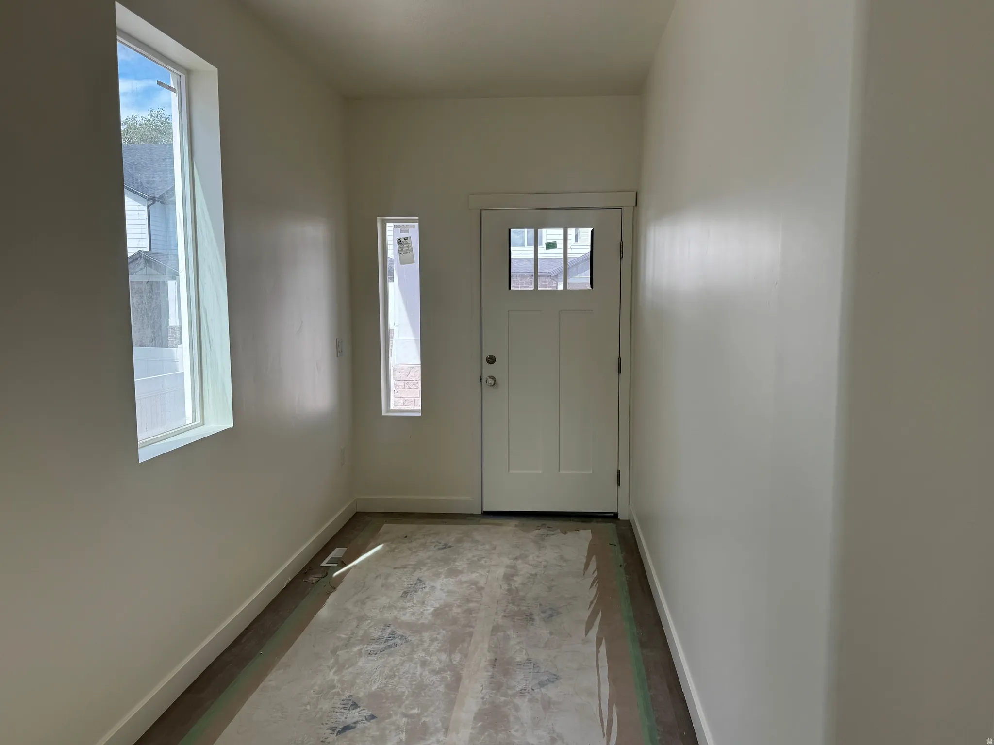 Entryway with a paneled door featuring multiple glass lites and a rectangular transom window