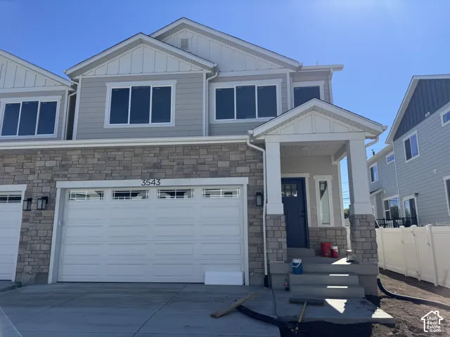 Exterior featuring stone and siding finishes