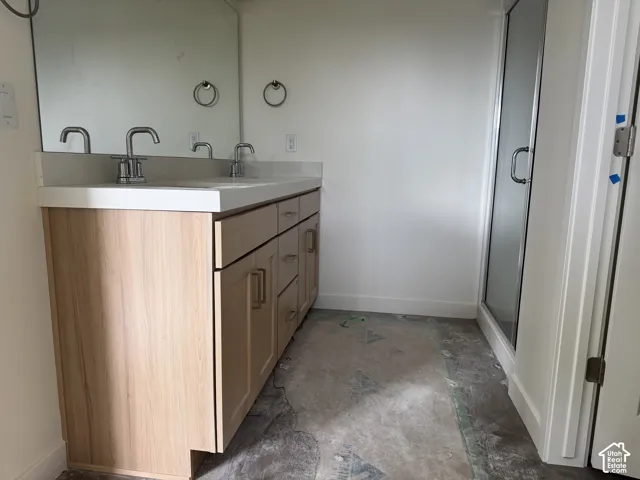 Dual vanity with a white countertop and chrome fixtures