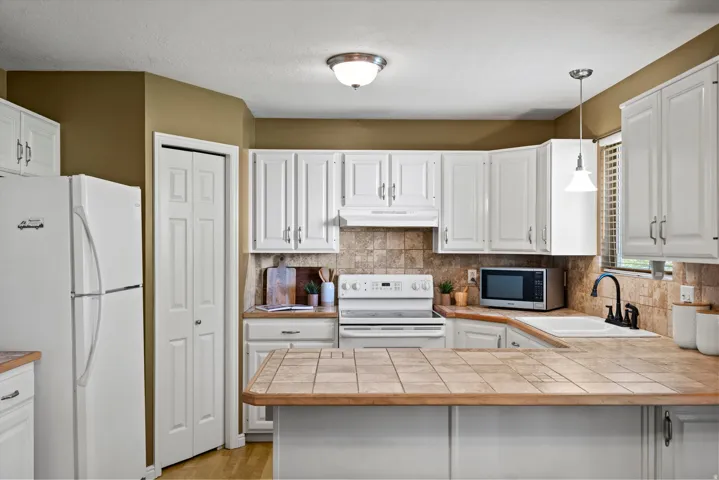 White shaker-style cabinetry with matte silver hardware