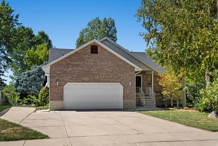 Brick-clad exterior with a prominent two-car garage