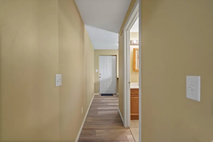 Wood-finish flooring throughout the hallway