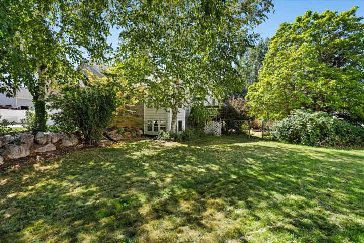 Expansive lawn area with mature trees and established landscaping